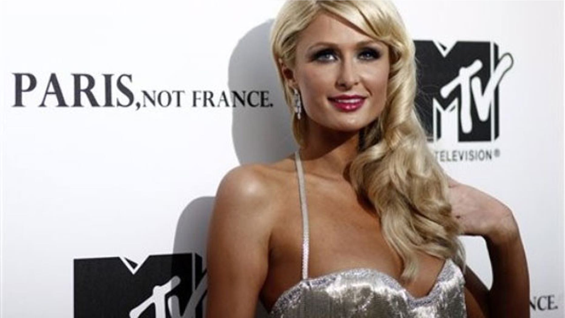 Paris Hilton is being sued by a fake hair company who pays her as a spokeswoman after she was spotted in a competitor's weave.