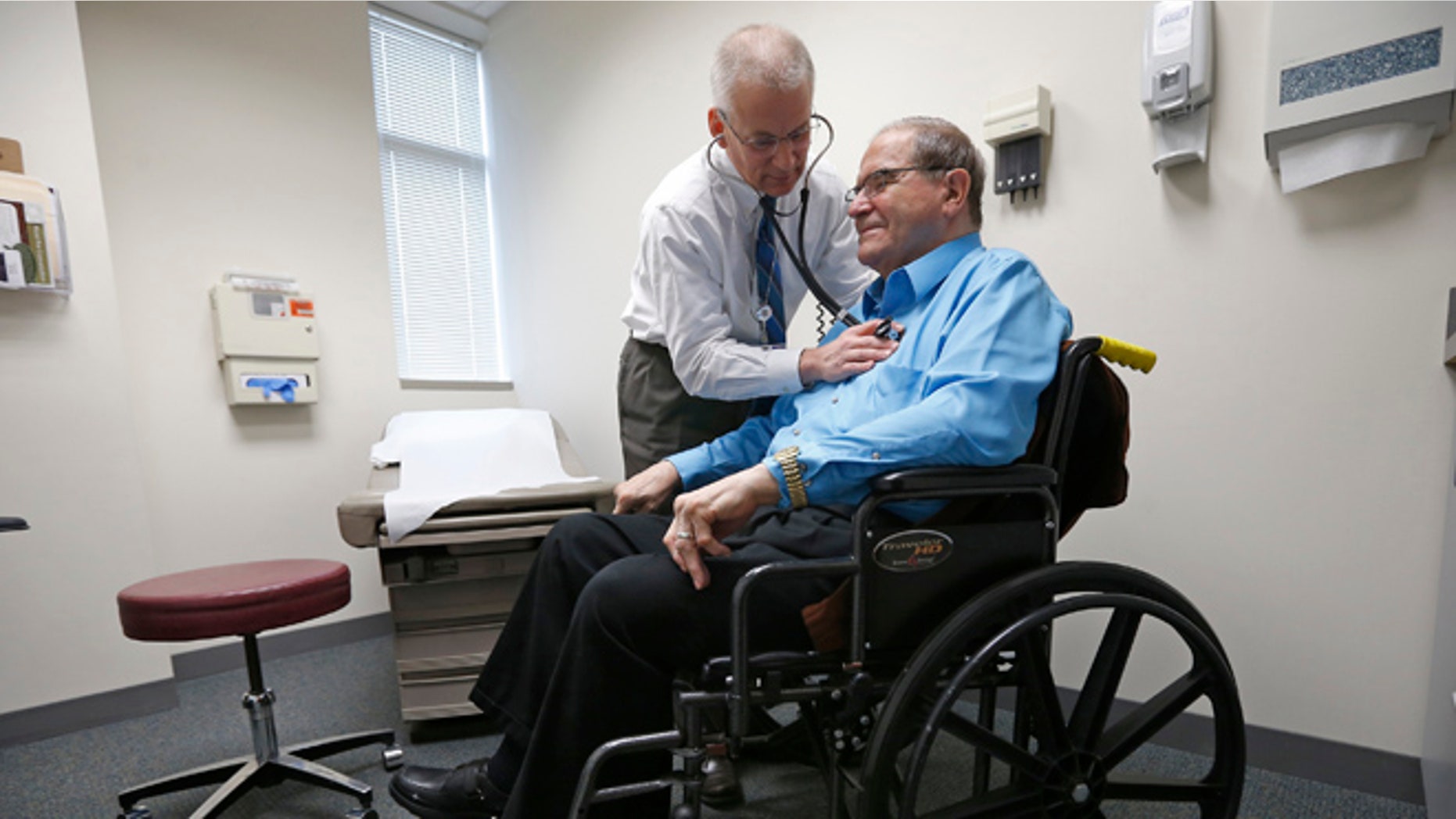 FILE: A doctor treats a patient at his office in Peoria, Illinois.