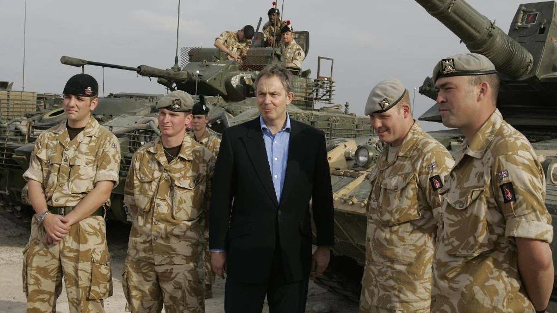 FILE- In this Thursday Dec. 22, 2005 file photo, the then Britain's Prime Minister Tony Blair meets soldiers at Shaibah logistics base, Basra, Iraq. Thirteen years after British troops marched into Iraq and seven years after they left a country that's still mired in violence, a mammoth official report, which will be published Wednesday July 6, 2016, is about to address the lingering question: What went wrong? (AP Photo/Kirsty Wigglesworth, File)