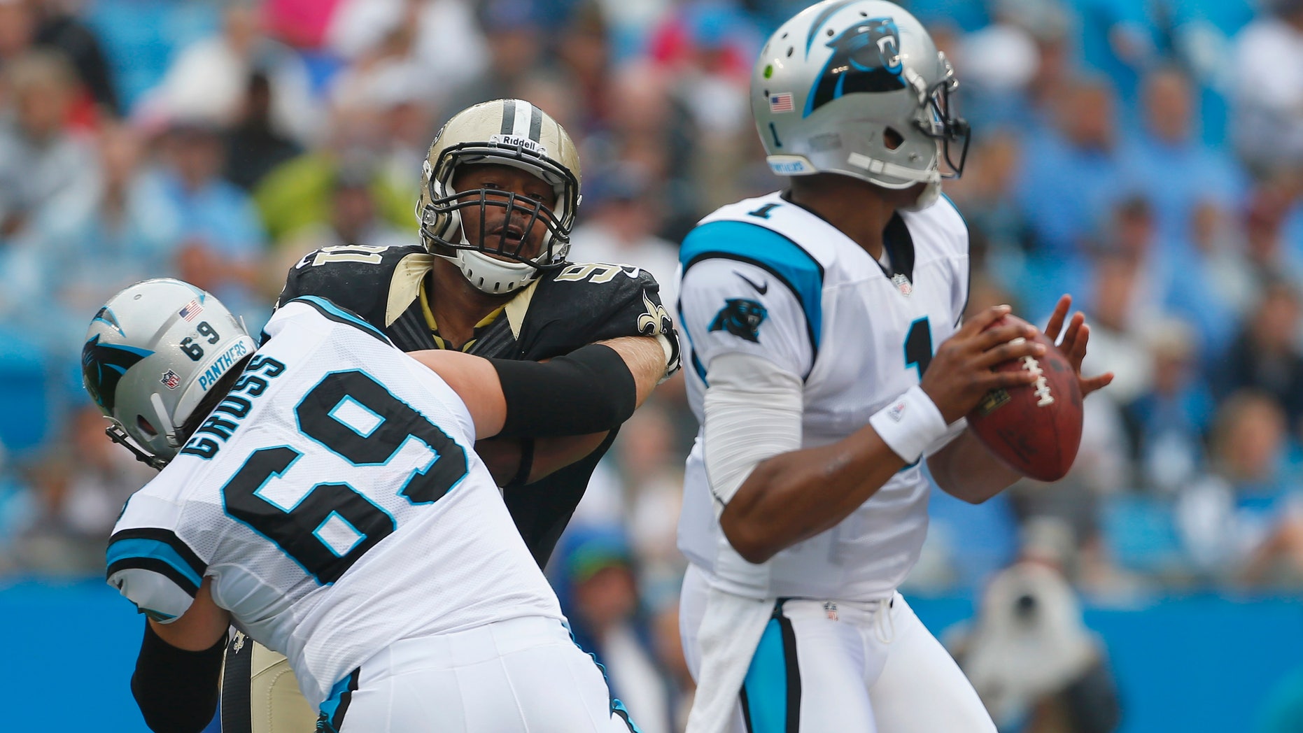 FILE - In this Sept. 16, 2012 file photo, Carolina Panthers left tackle Jordan Gross (69) keeps New Orleans Saints' Will Smith (91) blocked as Panthers quarterback Cam Newton (1) looks for a receiver during the first half of an NFL game in Charlotte, N.C. The Panthers will have to find someone new to protect Newton's blindside following the retirement of Gross. (AP Photo/Bob Leverone, File)