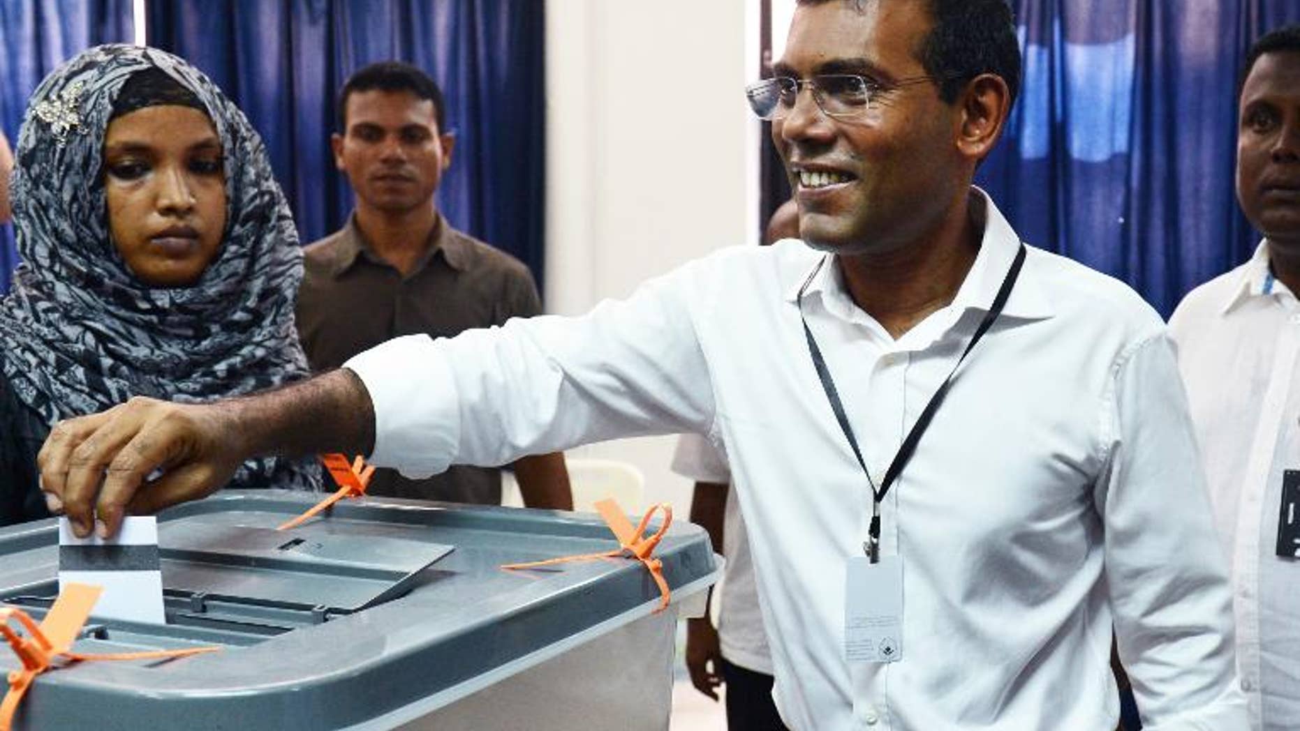 Maldivian former President and Presidential candidate Mohamed Nasheed smiles as he casts his vote at a local polling station in Male on September 7, 2013.