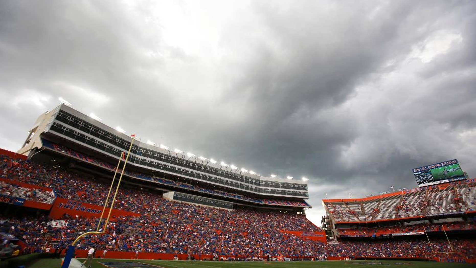 Dark clouds move over Ben Hill Griifin Stadium at Florida Field during a weather delay before the start of an NCAA college football game between Florida and Idaho in Gainesville, Fla., Saturday, Aug. 30, 2014. (AP Photo/John Raoux)