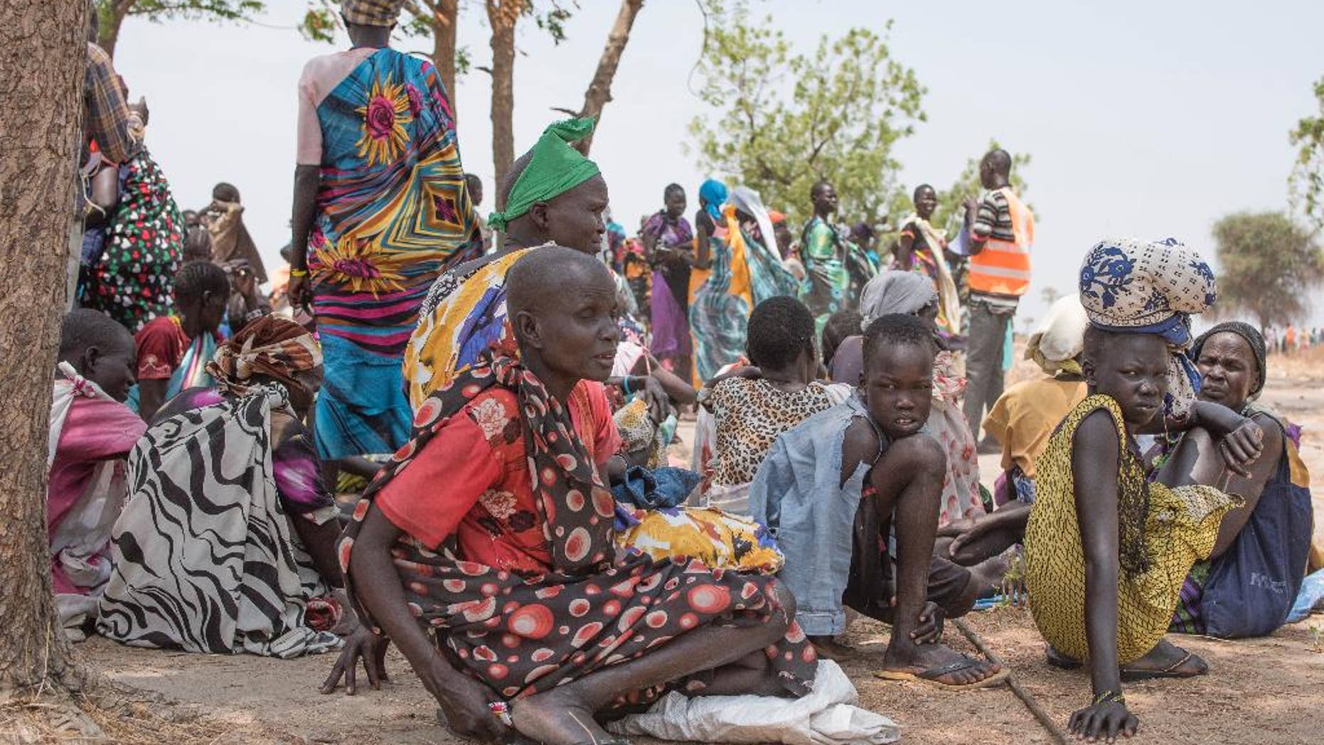 In this photo taken Tuesday, April 11, 2017, Women wait to receive food by ICRC at a site in Leer County region of South Sudan. Two months after a famine was declared in two counties amid its civil war, hunger has become more widespread than expected, aid workers say, region on the brink of starvation and people at risk of dying without sustained food assistance. (AP Photo)
