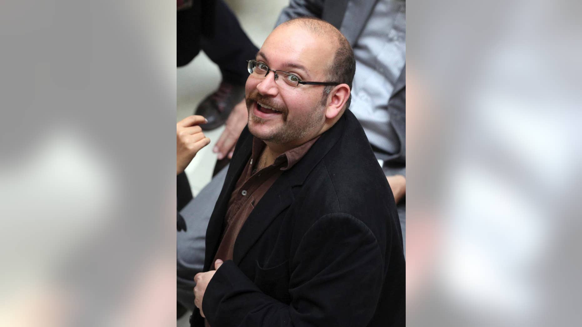 FILE - In this April 11, 2013 file photo, Jason Rezaian, an Iranian-American correspondent for the Washington Post smiles as he attends a presidential campaign of President Hassan Rouhani in Tehran, Iran. The trial of a Washington Post reporter detained in Iran for nearly 10 months will begin next week, a defense lawyer representing the Iranian-American journalist said Tuesday, May 19, 2015. (AP Photo/Vahid Salemi, File)