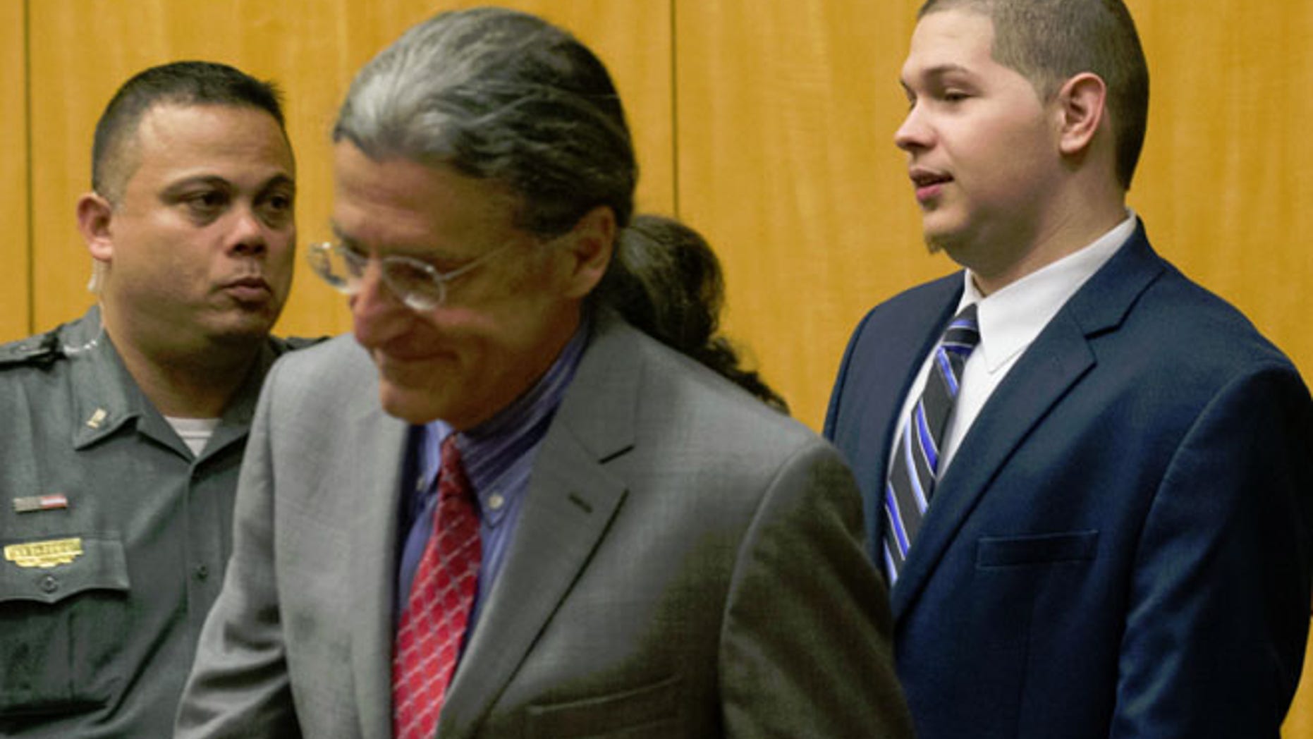 Tony Moreno, right, enters the courtroom in Middlesex Superior Court on Wednesday