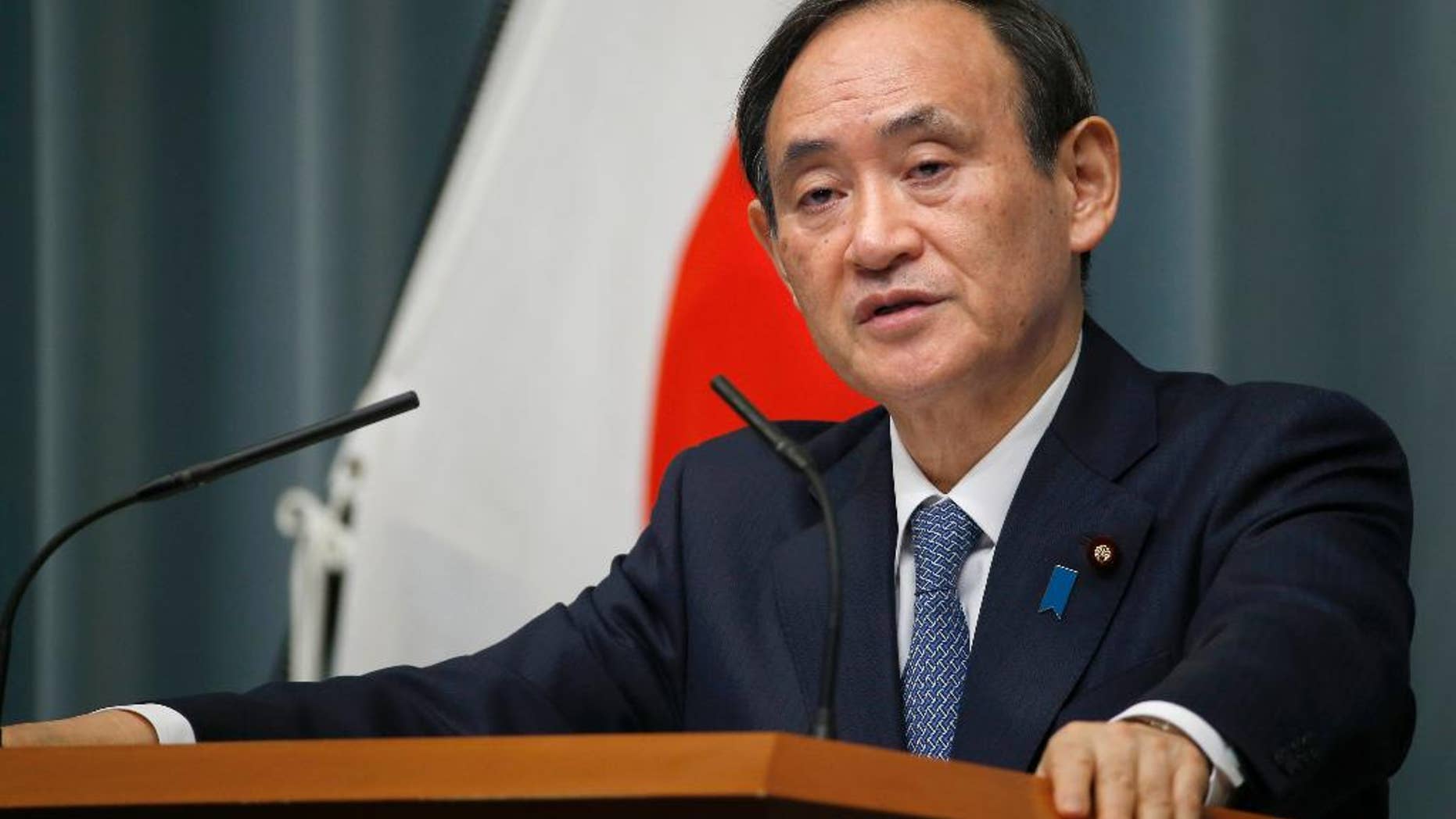 FILE - In this Feb. 10, 2016, file photo, Japan's Chief Cabinet Secretary Yoshihide Suga speaks to the media during a press conference at the prime minister's official residence in Tokyo. Japanese government spokesman Suga said Monday, March 28, 2016, that Japan would stand by its non-nuclear weapons stance, after U.S. presidential candidate Donald Trump said he would be open to Japan and South Korea having nuclear weapons. Suga told reporters Monday that “the three principles of not owning, making or allowing nuclear weapons remain important government basic policy.” (AP Photo/Shizuo Kambayashi, File)