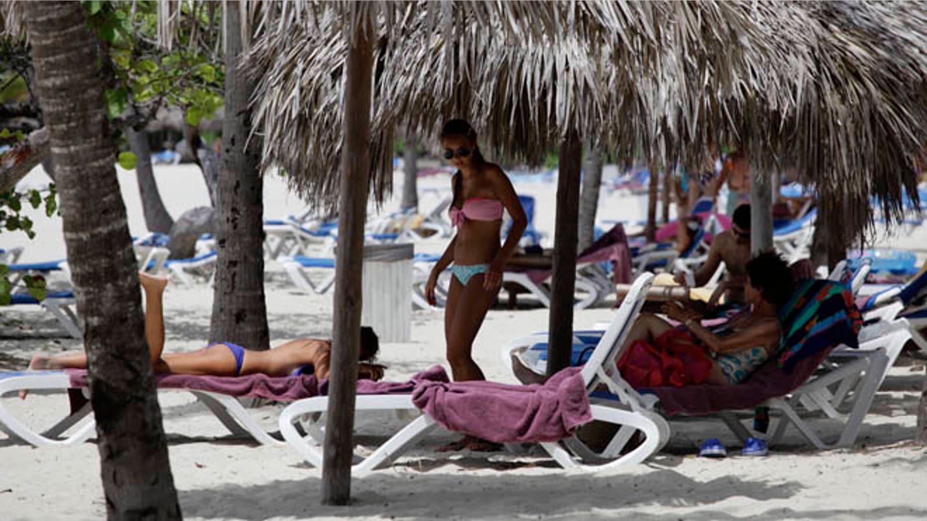 Foreign tourists use the beach at a five-star all-inclusive resort in Varadero, July 29, 2012. Cuba's beaches are an attraction for tourists the world over, whether they are foreigners paying thousands of dollars to reach them, or Cubans paying as little as five dollars for a three-day vacation in a seaside cabin. Picture taken July 29, 2012. REUTERS/Desmond Boylan (CUBA)