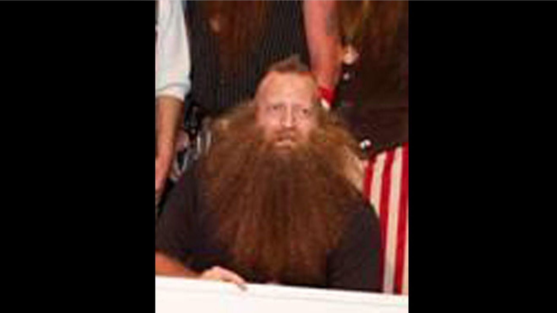 Jeff Langham accepts a check for winning the "Just for Men National Beard & Moustache Championships."