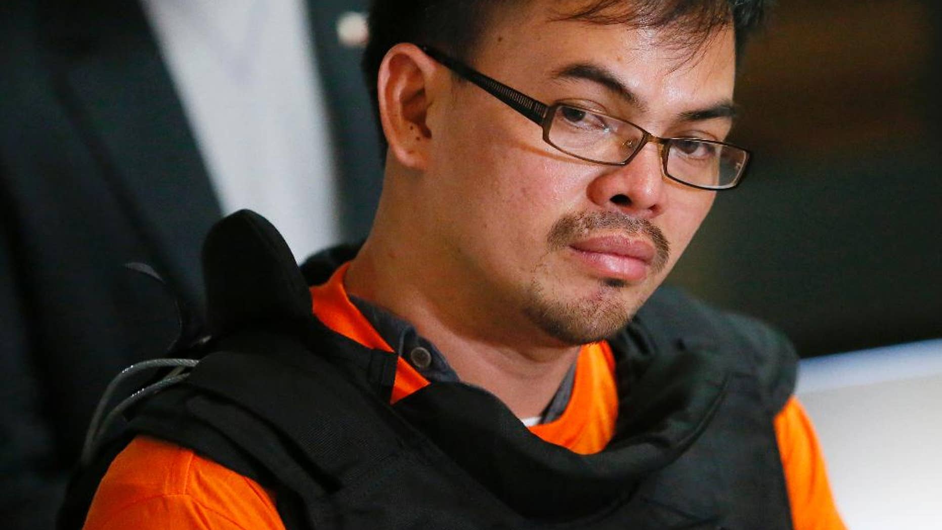 Alleged Filipino drug lord Kerwin Espinosa listens to a question as he is presented to the media upon arrival from Abu Dhabi early Friday, Nov. 18, 2016 at Camp Crame in suburban Quezon city, northeast of Manila, Philippines. Espinosa, whose father Mayor Rolando Espinosa was killed inside his detention cell, told a news conference he will "tell all" those involved in the illegal drug trade in the country. (AP Photo/Bullit Marquez)