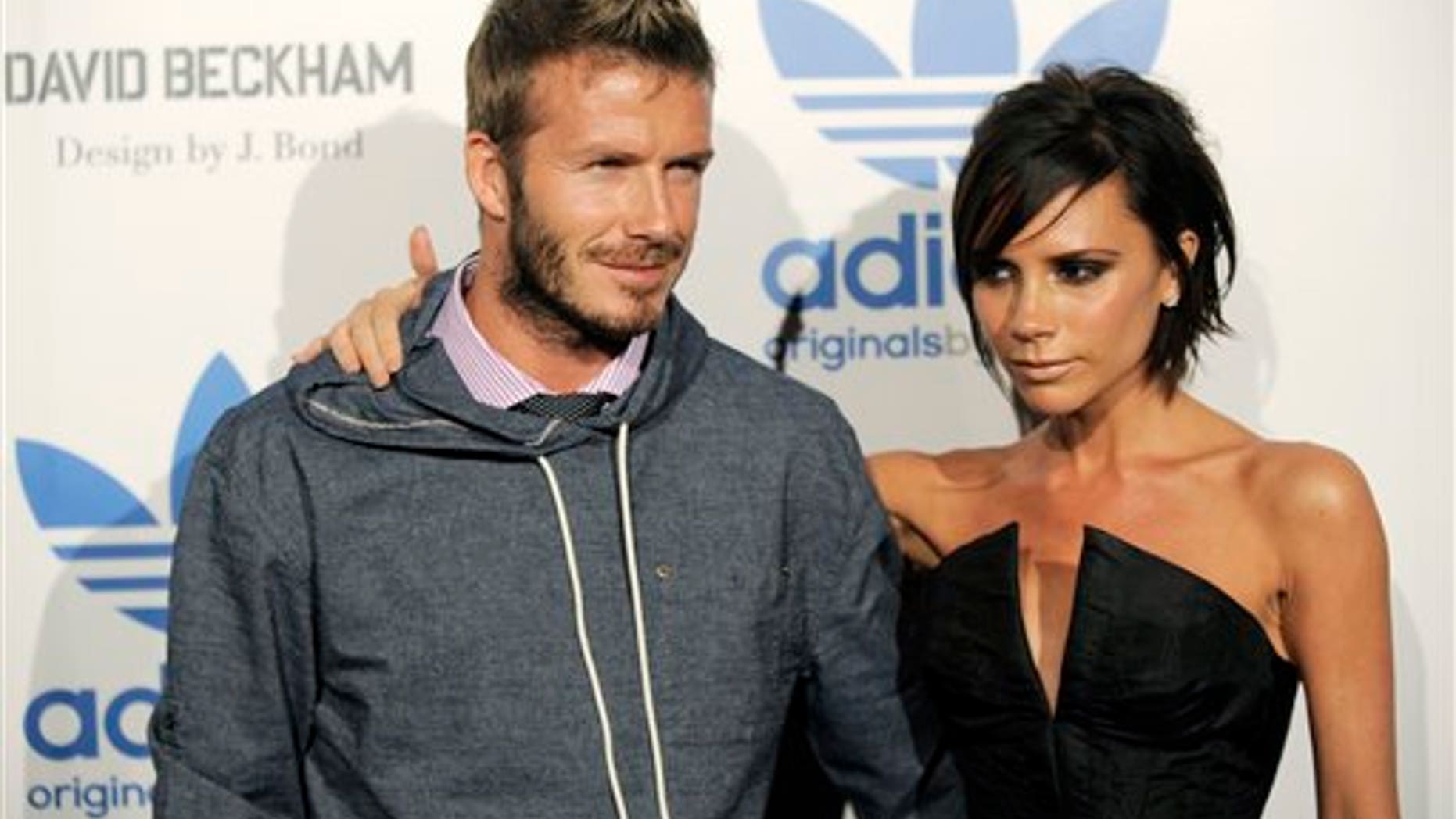 David Beckham and his wife Victoria arrive at an event to celebrate the launch of the Adidas Originals by Originals David Beckham clothing line designed by James Bond, Wednesday, Sept. 30, 2009, in Los Angeles. (AP Photo/Chris Pizzello)