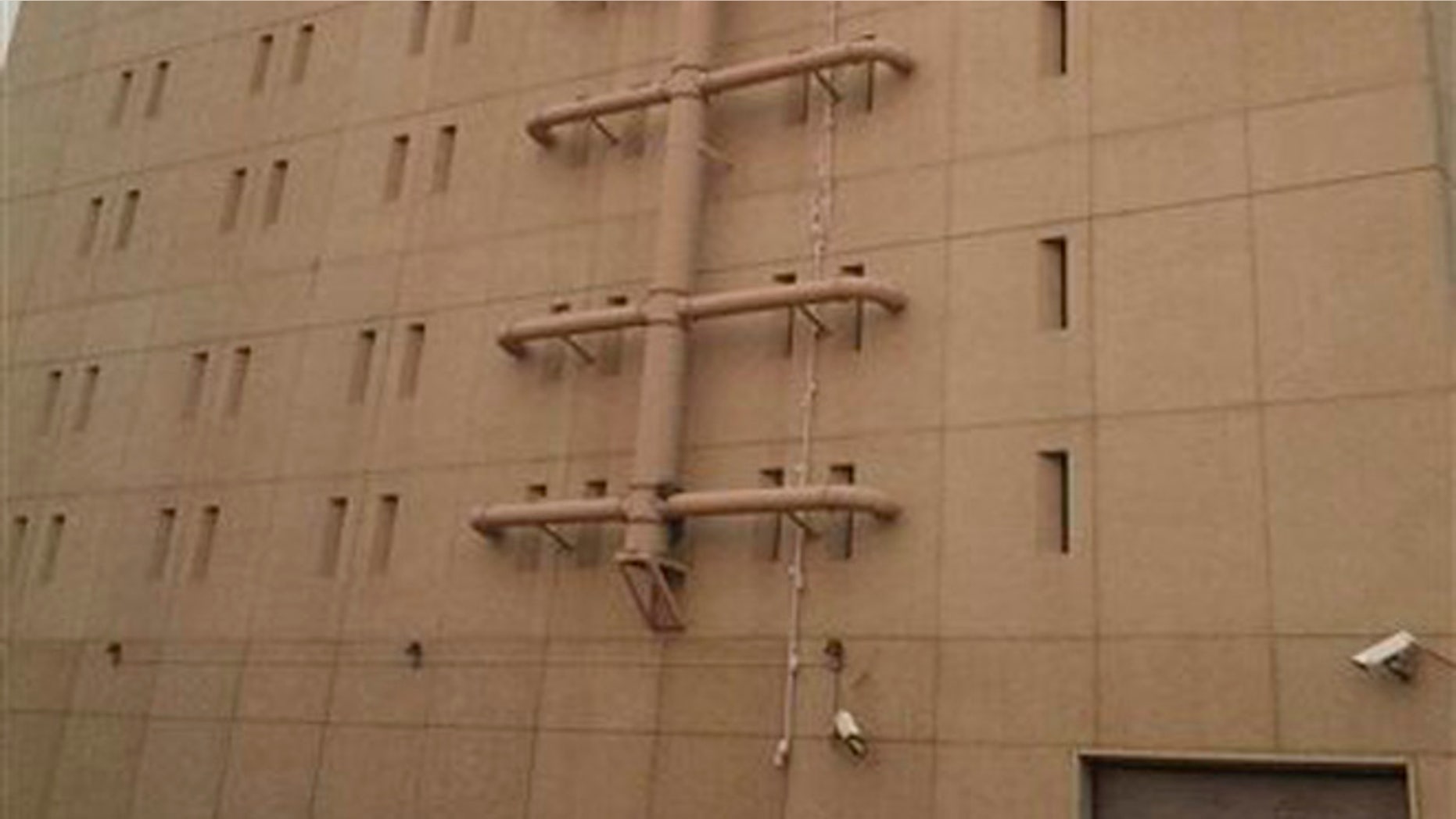 Aug. 20, 2015: In this image made from video taken, bed sheets used in an apparent escape attempt are seen hanging from a top floor window of the Spokane County Jail reaching all the way to the ground in Spokane, Wash.