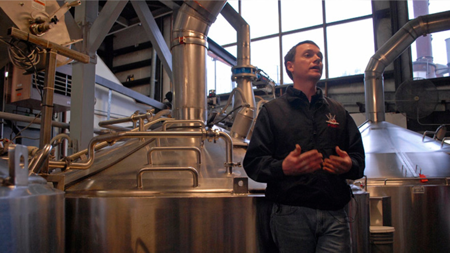 Brandon Smith, the Alaskan Brewing Co.'s brewing operations and engineering manager, speaks to reporters about the company's new boiler system. The brewery has installed a unique boiler system that burns the company's spent grain the accumulated waste from the brewing process into steam which powers the majority of the plant's operations.