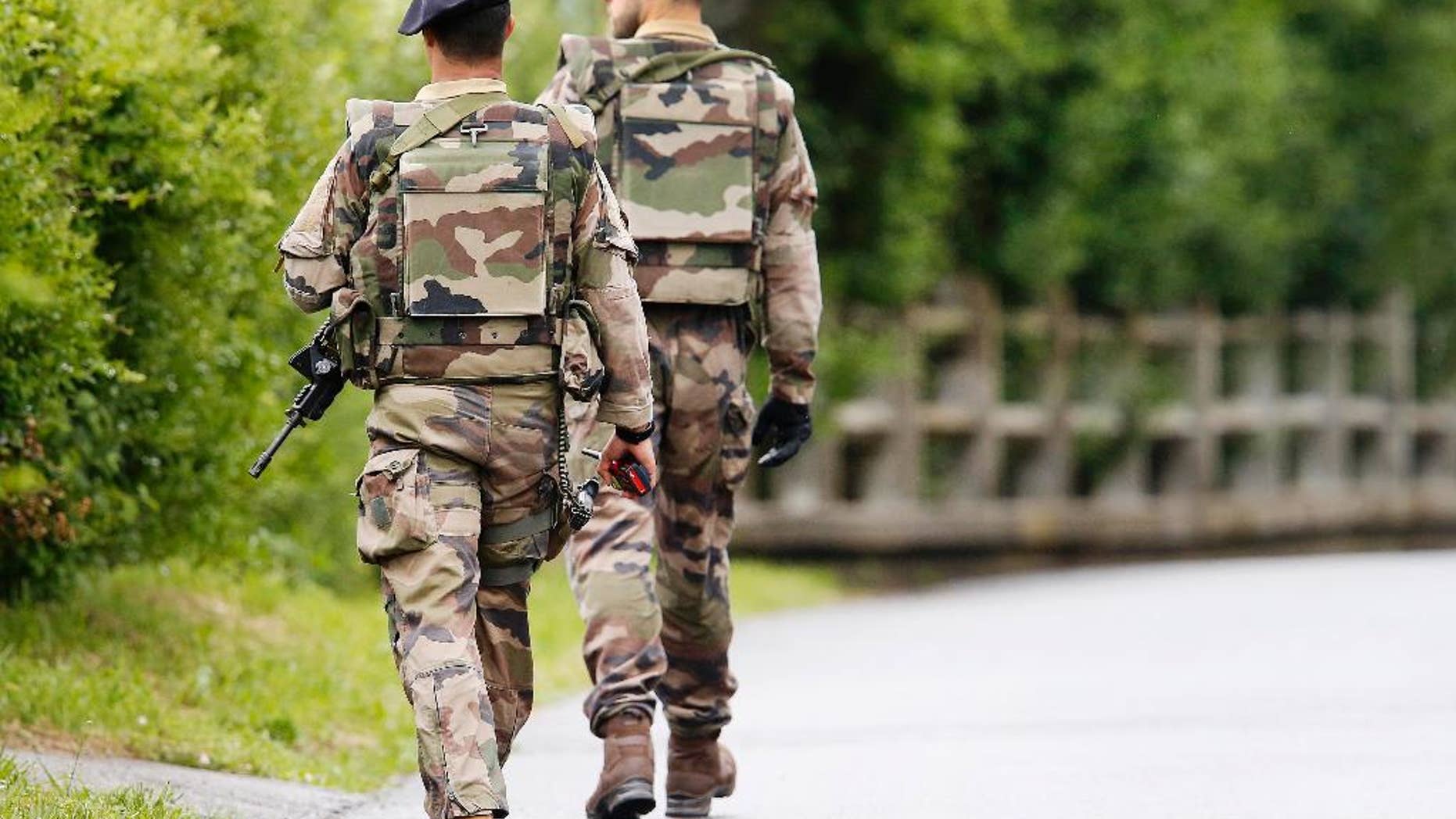 French soldiers patrol near the Camille Fournier stadium at their base camp in Evian, France, Wednesday, June 8, 2016. Germany will face the Ukraine in a Euro 2016 Group C soccer match in Lille on Sunday, June, 12, 2016. (AP Photo/Michael Probst)