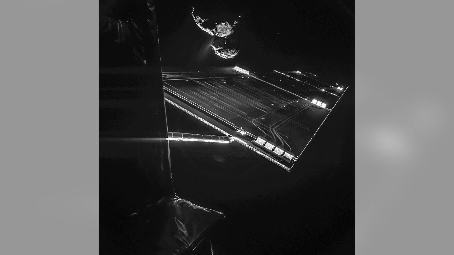 The image composed of two different images and provided by the European Space Agency ESA on Wednesday, Oct. 15, 2015 shows parts of the spacecraft Rosetta in front of the comet 67P/Churyumov–Gerasimenko from a distance of about 16 km from the surface of the comet. The image was taken on 7 October and captures the side of the Rosetta spacecraft and one of Rosetta’s 14 m-long solar wings, with the comet in the background. Two images with different exposure times were combined to bring out the faint details in this very high contrast situation. The comet's active ‘neck’ region is clearly visible, with streams of dust and gas extending away from the surface. (AP Photo/ESA)