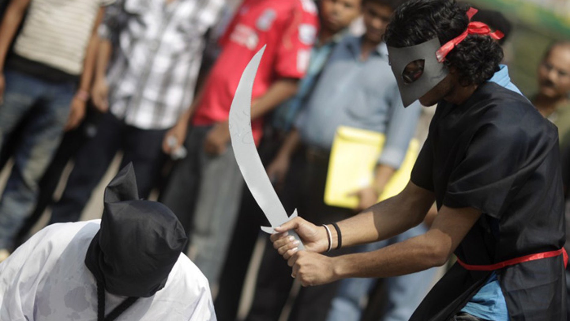 Members of Magic Movement stage a mock execution in protest against beheadings in Saudi Arabia (Reuters)