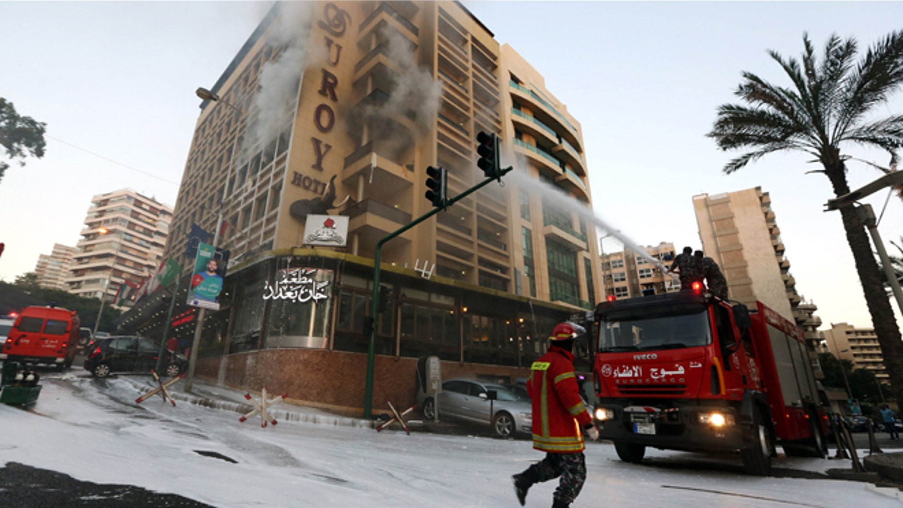 June 25, 2014: Fire engines work on extinguishing a fire after a suicide bomber blew himself up in his room at a Beirut hotel, Lebanon, as Lebanese security forces raided the premises. The bombing is the latest in a string of attacks and security sweeps in Lebanon over the past week that have sparked fears of renewed violence in a country that has been deeply affected by the civil war in neighboring Syria.