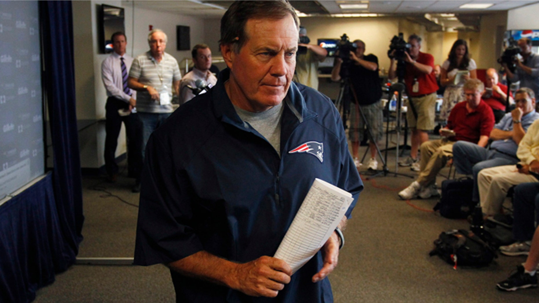 FILE 2013: New England Patriots head coach Bill Belichick leaves a news conference after addressing the media regarding the criminal charges against Aaron Hernandez in Foxboro, Mass.