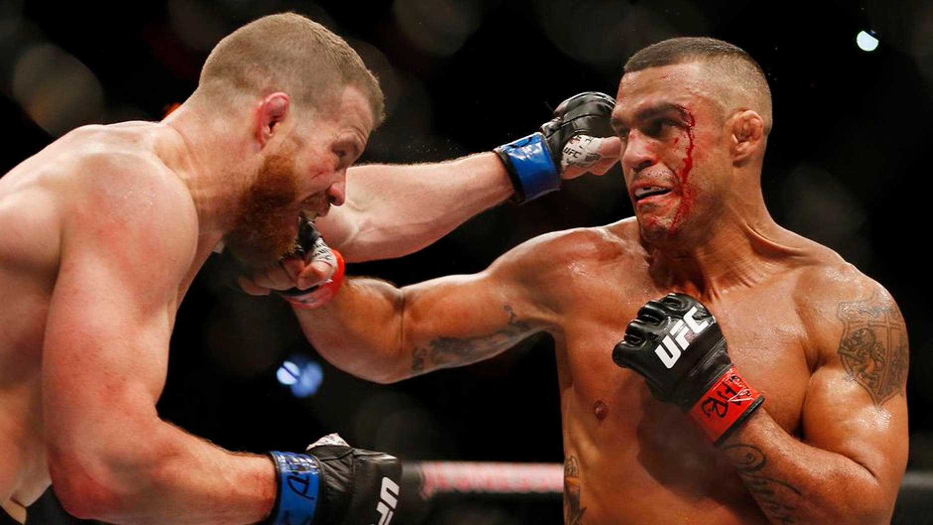 Vitor Belfort, right, of Brazil, trades blows with Nate Marquardt, of the United States, during their UFC middleweight mixed martial arts bout in Rio de Janeiro, Brazil, early Sunday, June 4, 2017. (AP Photo/Leo Correa)