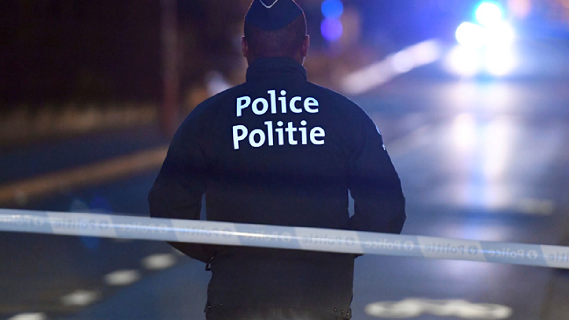 A police officer stands at a cordon during the investigation of a suspect car in the center of Brussels on Thursday, March 2, 2017. Belgian authorities have closed off part of the center of Brussels and a subway station after a suspect was detained with gas canisters in the trunk of his car. (AP Photo/Geert Vanden Wijngaert)
