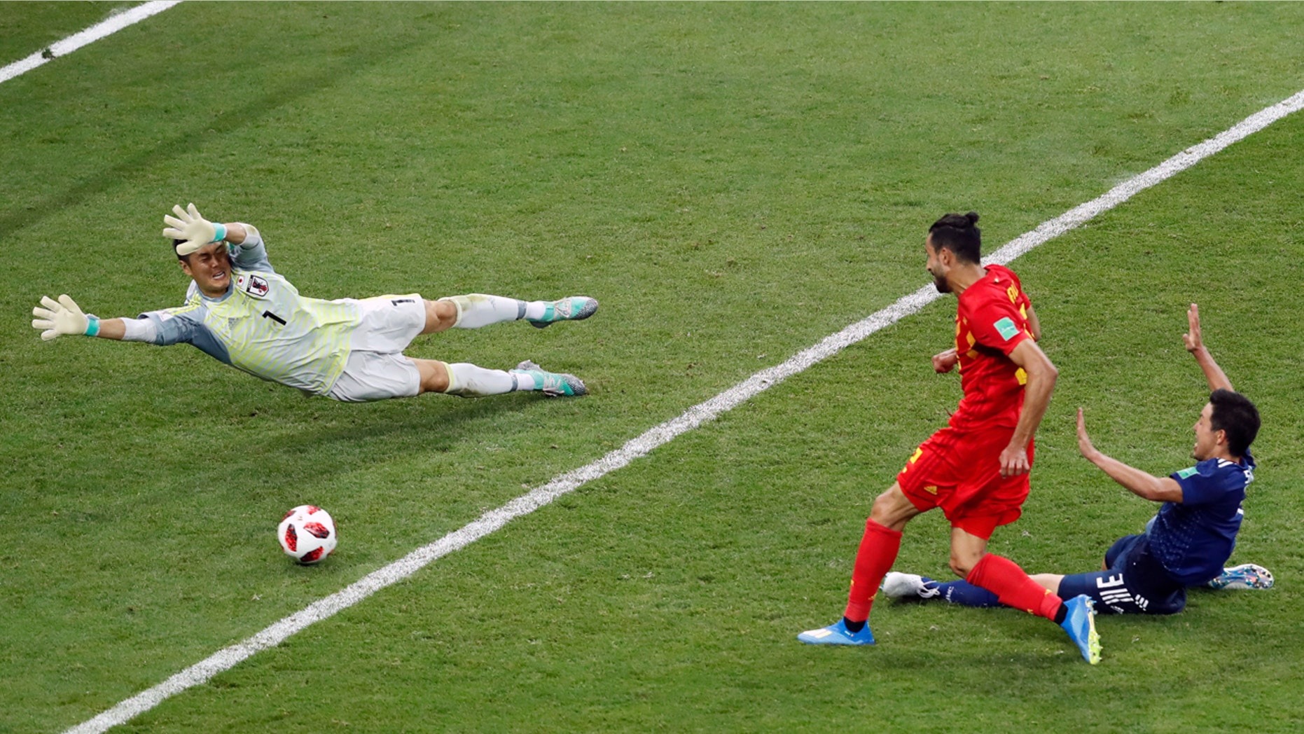 Belgium's Nacer Chadli scores the winning goal past Japanese keeper Eiji Kawashima in the World Cup last 16 match.
