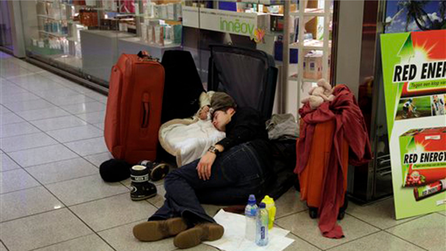 Dec. 24, 2010: A man sleeps with his infant in a suitcase at Zaventem airport in Brussels. A new batch of snow caused air traffic chaos in Belgium on Friday, with its main airport either canceling or delaying many flights.