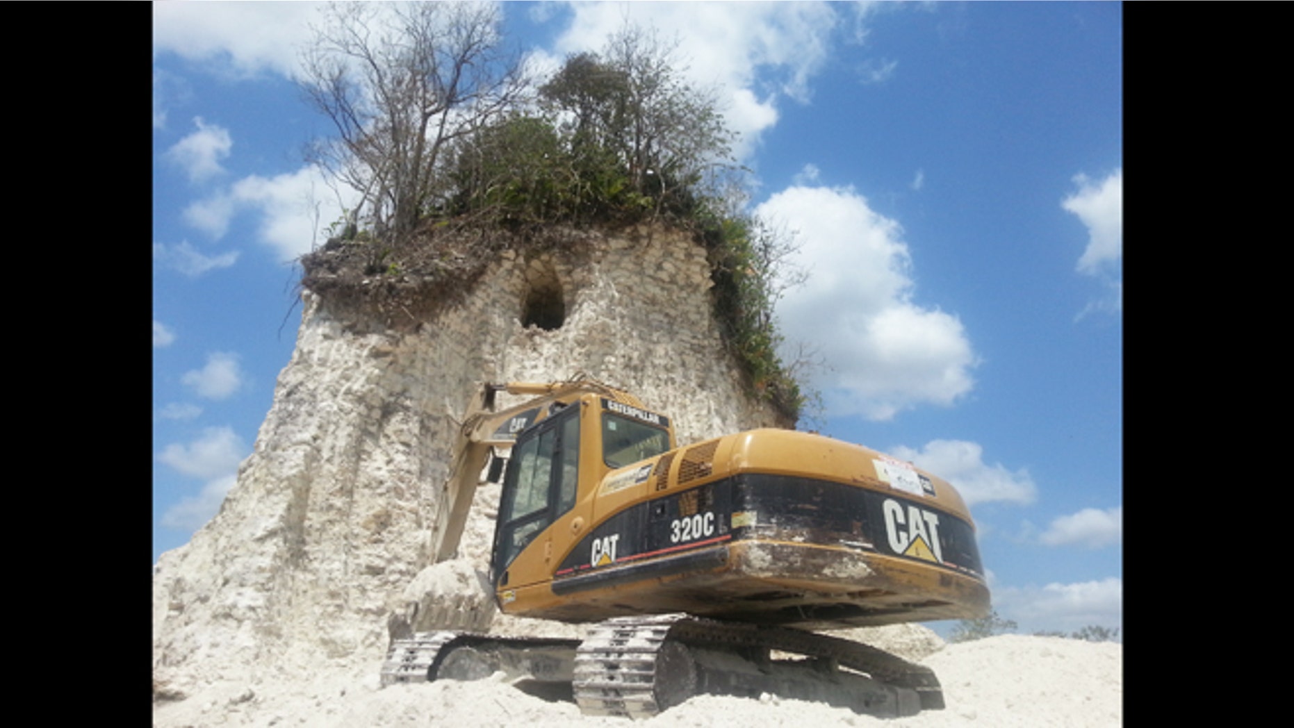 Heavy construction equipment sits dormant at the remains of a partially destroyed Mayan temple, part of the 3,200 year old site known as Noh Mul or "Big Hill."