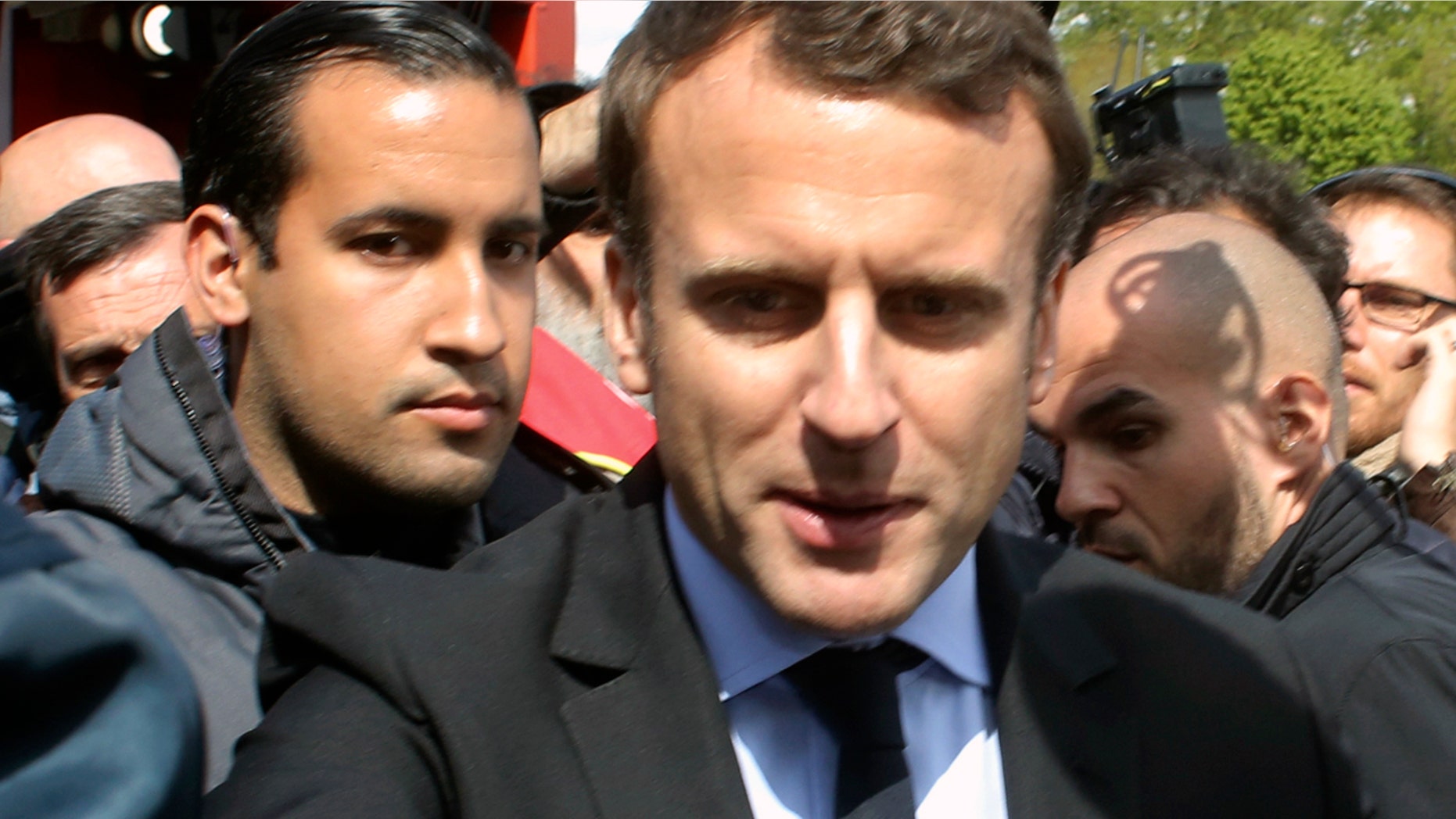 Alexandre Benalla stands with Emmanuel Macron during last year's French presidential election campaign. Benalla, now a top security aide to Macron, was caught on camera beating a May Day protester.