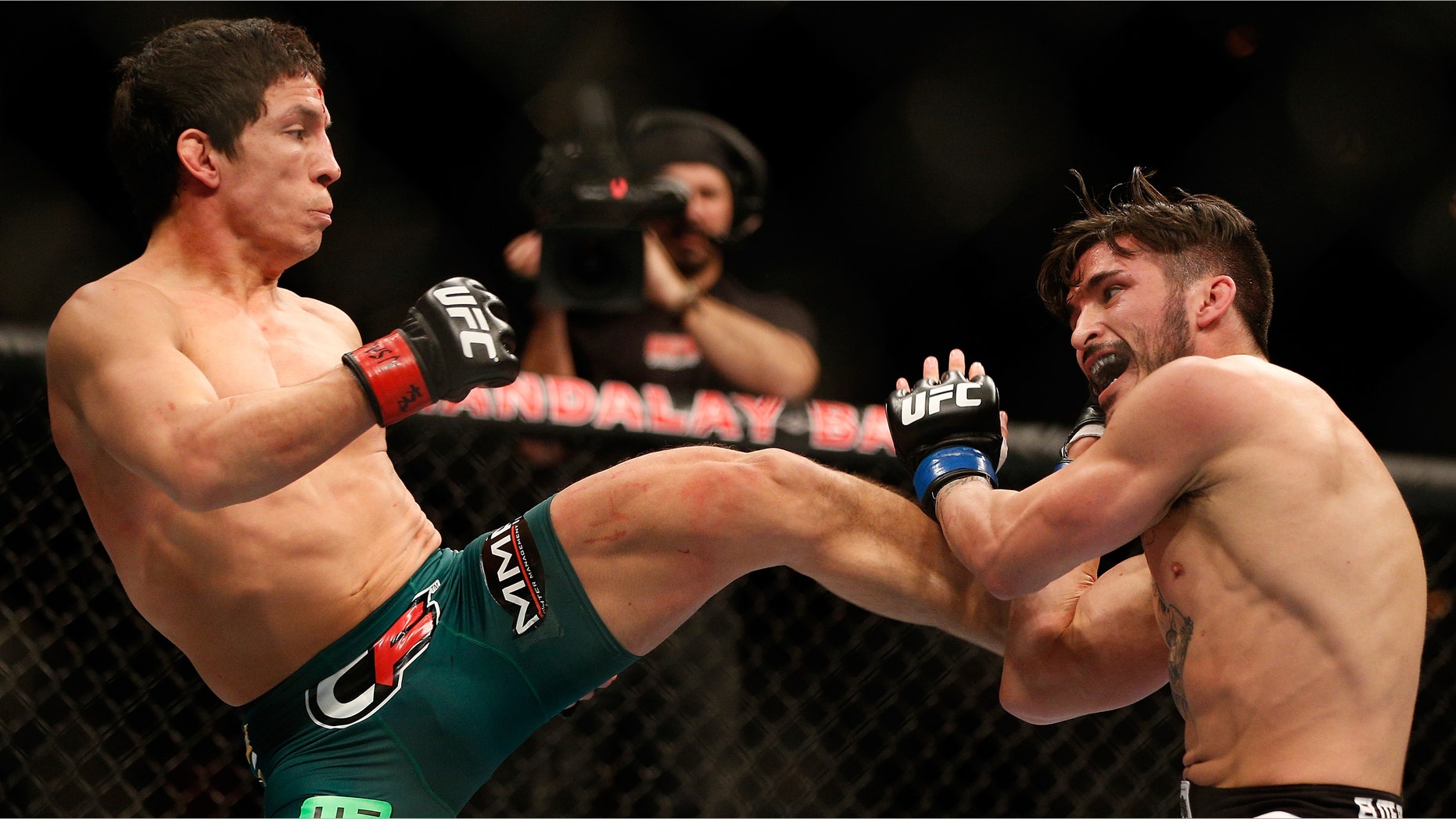 LAS VEGAS, NV - FEBRUARY 02: (L-R) Joseph Benavidez kicks Ian McCall during their flyweight fight at UFC 156 on February 2, 2013 at the Mandalay Bay Events Center in Las Vegas, Nevada. (Photo by Josh Hedges/Zuffa LLC/Zuffa LLC via Getty Images)