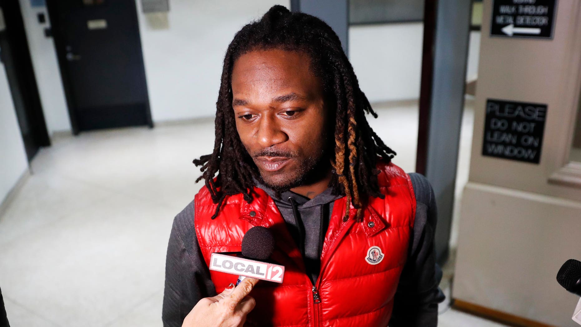 Bengals cornerback Adam "Pacman" Jones speaks to reporters as he is released from the Hamilton County Justice Center after be charged with felony harassment with a bodily substance, , Wednesday, Jan. 4, 2017, in Cincinnati. He is also charged with assault, disorderly conduct and obstructing police. An attorney representing Jones has told a Hamilton County judge that he "vehemently denies" the charges that led to his arrest. (AP Photo/John Minchillo)