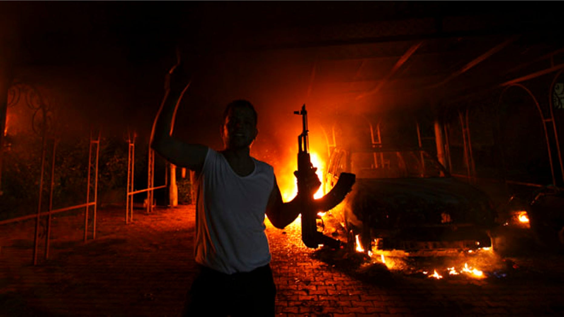 Sept. 11, 2012: A protester reacts as the U.S. Consulate in Benghazi is seen in flames. (Reuters)