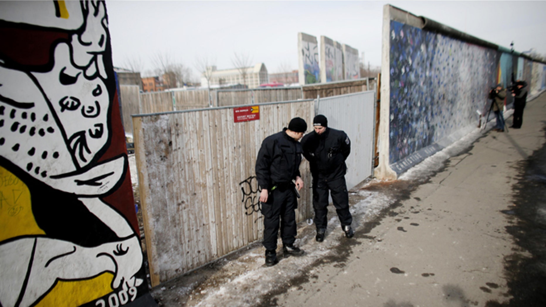 March 27, 2013: Police officers guard a construction site and sections of the East Side Gallery, while parts of the former Berlin Wall are removed in Berlin, Germany. Work crews backed by about 250 police have removed portions of the Berlin Wall known as the East Side Gallery to make way for an upscale building project, despite demands by protesters that the site be preserved. Plans to remove part of the 3/4-mile stretch of wall sparked protests that developers were sacrificing history for profit.