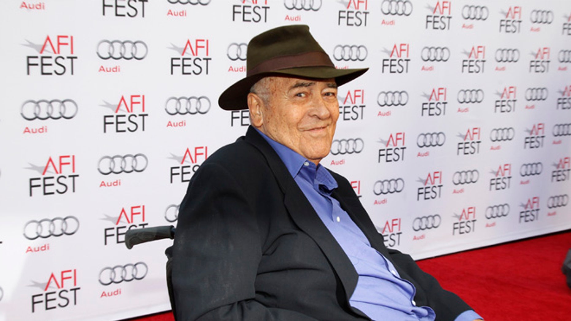 Italian director Bernardo Bertolucci smiles during an interview as he arrives for a gala screening of his film "The Last Emperor" in 3D at the AFI Fest 2013 in Hollywood, California, November 10, 2013. REUTERS/Fred Prouser (UNITED STATES - Tags: ENTERTAINMENT) - RTX158LK