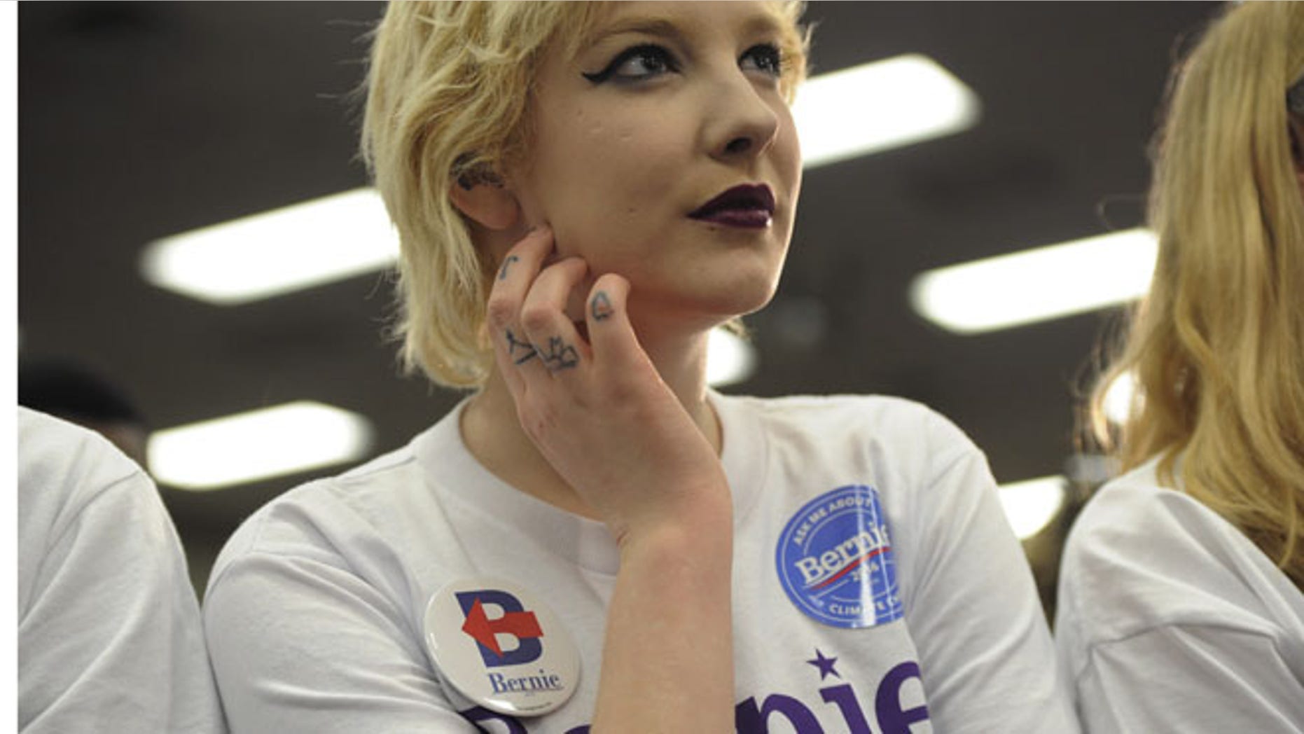 Alli Scholl, a supporter of U.S. Democratic presidential candidate Bernie Sanders, listens as he speaks at a campaign rally in Waterloo, Iowa January 31, 2016. REUTERS/Mark Kauzlarich - RTX24U58