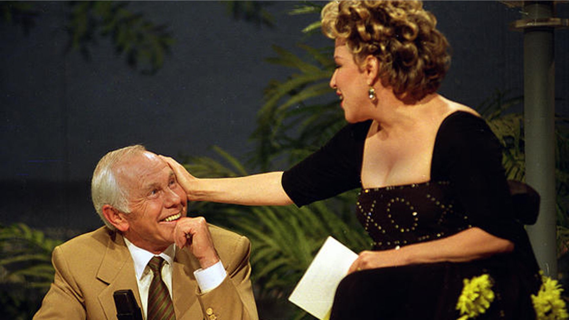 Entertainer Bette Midler caresses talk show host Johnny Carson during his next-to-last taping of "The Tonight Show" in Burbank, Ca., Thursday, May 21, 1992.