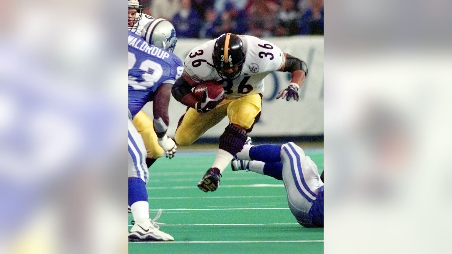 Pittsburgh Steelers running back Jerome Bettis breaks through a hole during the second quarter against the defense of the Detroit Lions in Pontiac, Mich., Thursday, Nov. 26, 1998. (AP Photo/Duane Burleson)