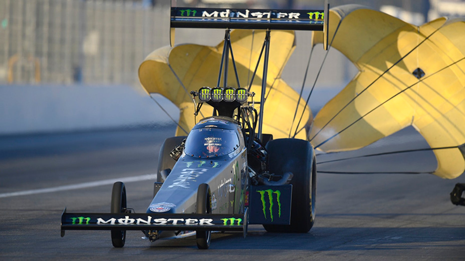 In this photo provided by the NHRA, Brittany Force slows after a run in Top Fuel qualifying at the Auto Club NHRA Finals drag races at Auto Club Raceway, Saturday, Nov. 11, 2017, in Pomona, Calif. Force's qualifying run Friday held up for the No. 1 spot. (Marc Gewertz/NHRA via AP)