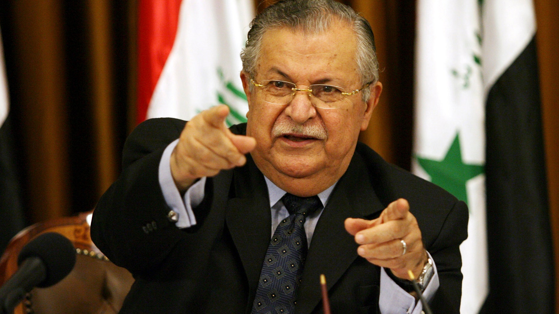 FILE - In this Aug 17, 2007 file photo, Iraq's President Jalal Talabani talks to reporters in Baghdad, Iraq. The office of Iraqi President Jalal Talabani said Tuesday he has been admitted to the hospital for treatment of an unspecified health problem.. (AP Photo/Hadi Mizban, File)