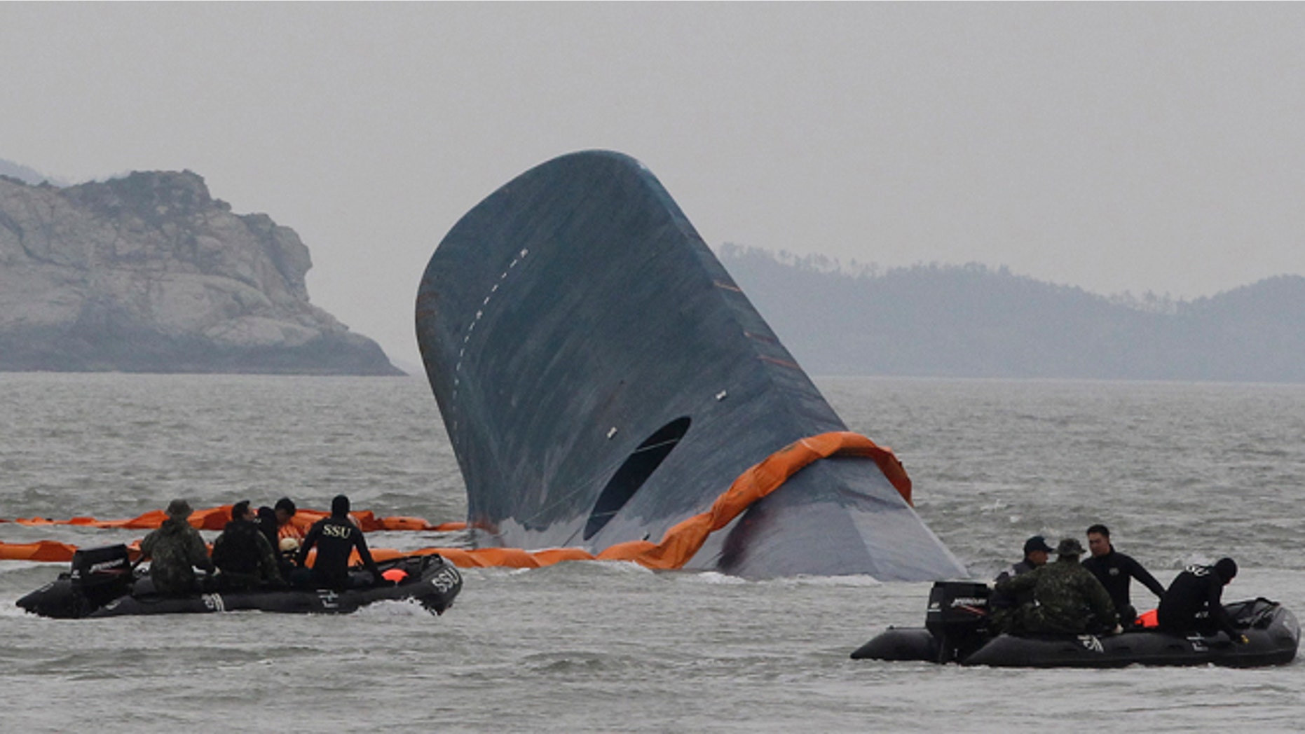April 17, 2014: South Korean Coast Guard officers search for missing passengers aboard sunken ferry Sewol in the waters off the southern coast near Jindo, South Korea.