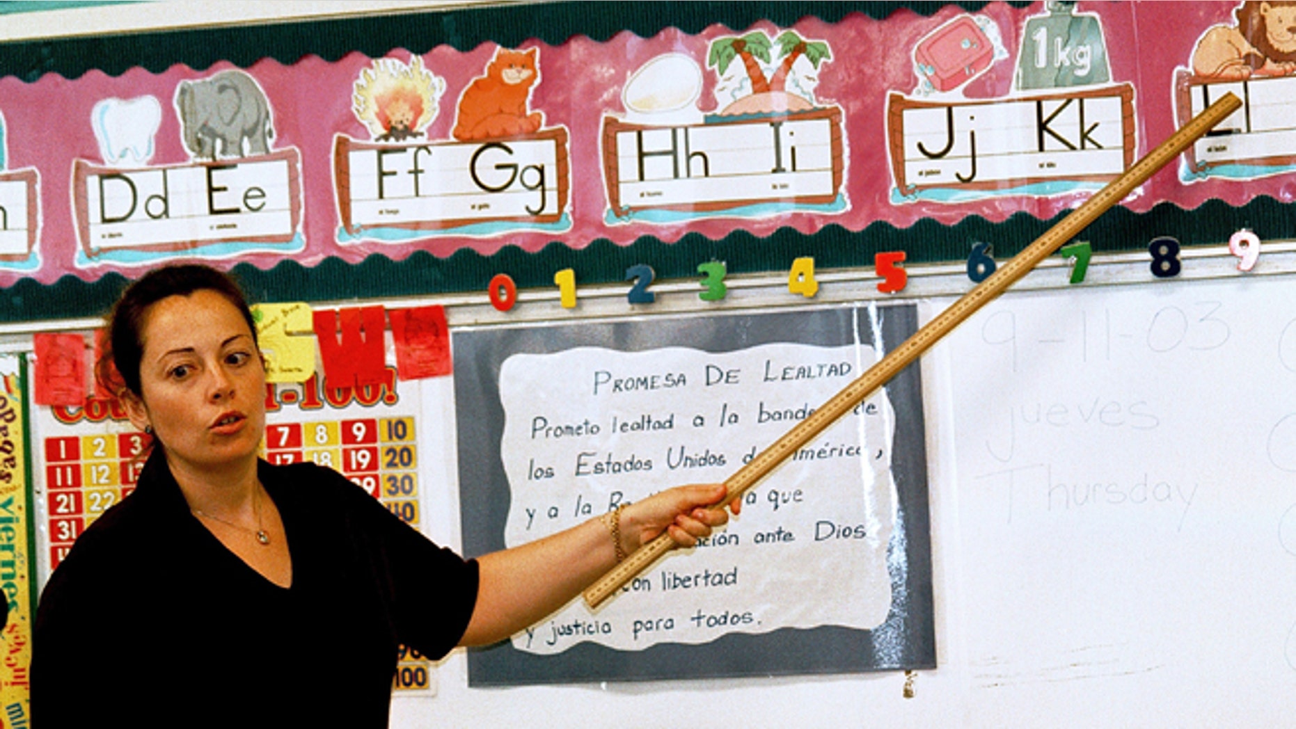 TYLER,TX - SEPTEMBER 11: Lourdes Carmona, a Spanish speaking first grade teacher, instructs a class on the Spanish pronunciations of the alphabet at Birdwell Elementary School September 11, 2003 in Tyler, Texas. Carmona, a native of Spain, was recruited 5 years ago to teach Spanish speaking youngsters reading, writing, and arithmetic in their native language, as there was and continues to be a shortage of bilingual teachers in Texas. Carmona and her husband, also a native of Spain, are both employed by the Tyler Independent School District and permanently live in the east Texas city. (Photo by Mario Villafuerte/Getty Images)