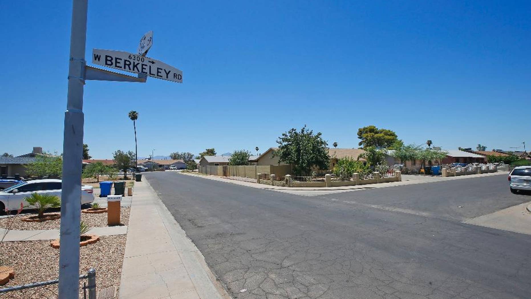 Near this block of West Berkeley Road in the Maryvale section of Phoenix, three persons died in one of a rash of shootings, shown here during the day Friday, July 8, 2016. Angela Linner, 31, Stefanie Ellis, 33, and Maleah Ellis, 12, were shot on June 12 outside a home on the street, one of the victims, Stefanie Ellis, died of her injuries this past Thursday. (AP Photo/Ross D. Franklin)