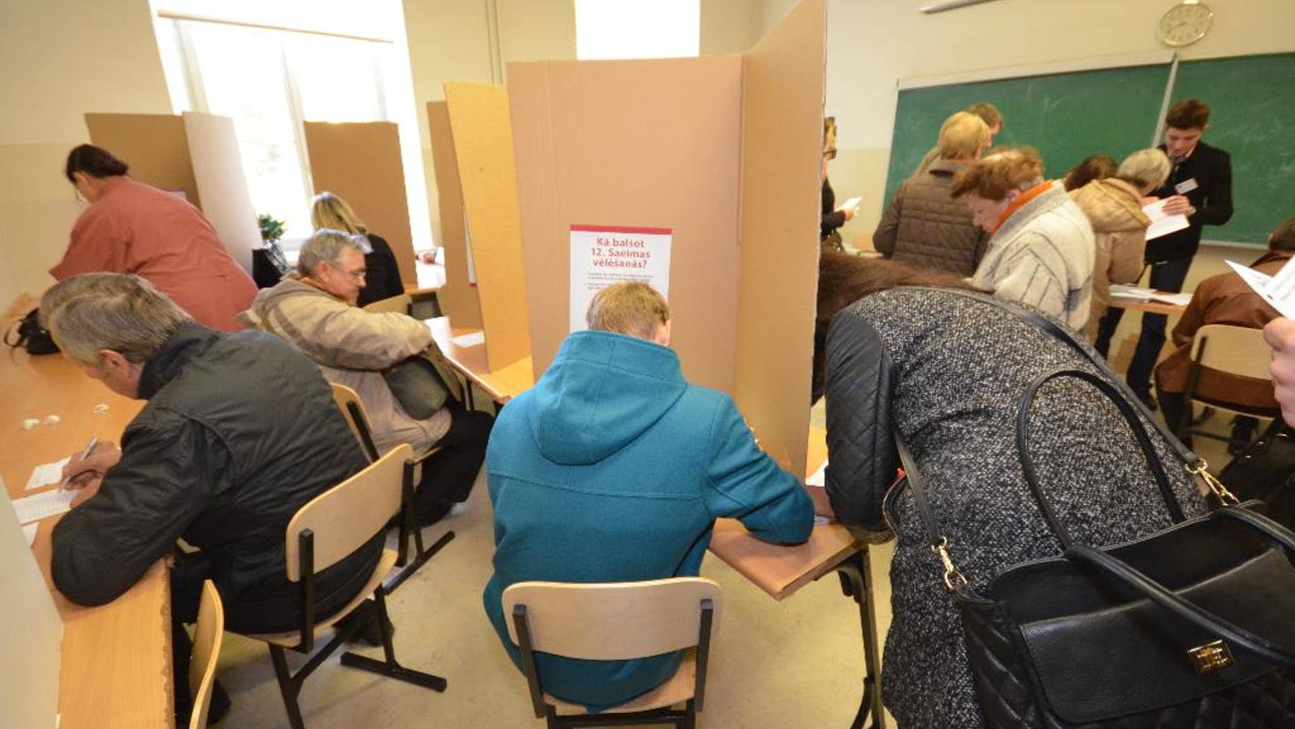 Latvian voters cast advance ballots at a high school in Riga on Thursday, Oct. 2, 2014. The Baltic country is holding a Parliamentary election on Oct. 4, amid worries over Russia’s intervention in Ukraine. (AP Photo/Tor Bernhard Slaathaug)