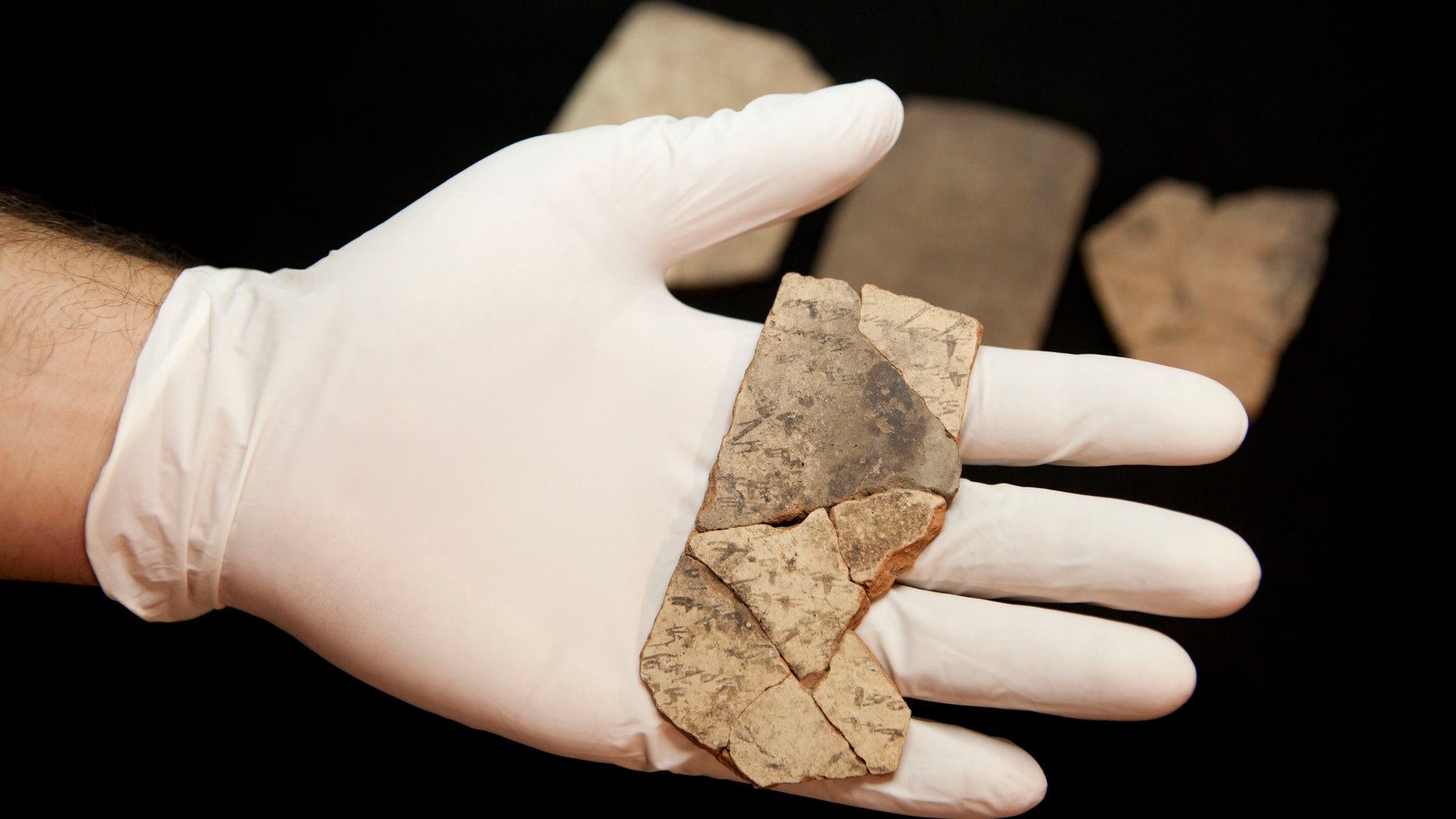 Letters inscribed on pottery, known as ostracons, which were unearthed in an excavation of a fort in Arad, Israel, and dated to about 600 B.C. shortly before Nebuchadnezzar's destruction of Jerusalem, are seen in Israel Museum in Jerusalem Tuesday, April 12, 2016. (AP Photo/Dan Balilty)
