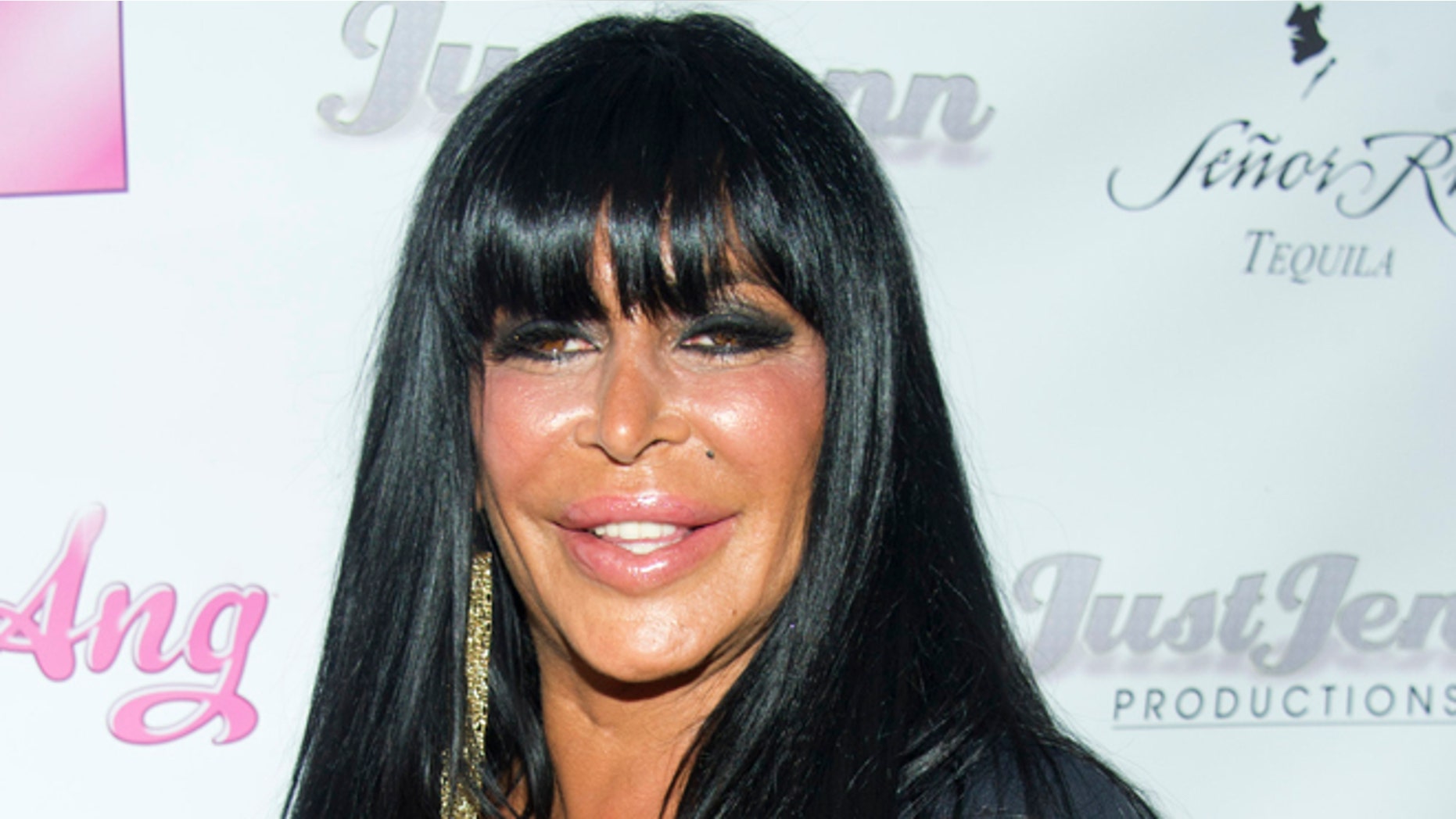 July 8, 2012. Angela Raiola, known as "Big Ang," and her dog Little Louie arrive to the premiere of her VH1 reality show "Big Ang" in New York.