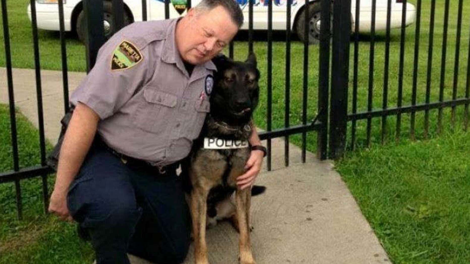 Matthew Hickey puts his arms around K-9 partner Ajax.
