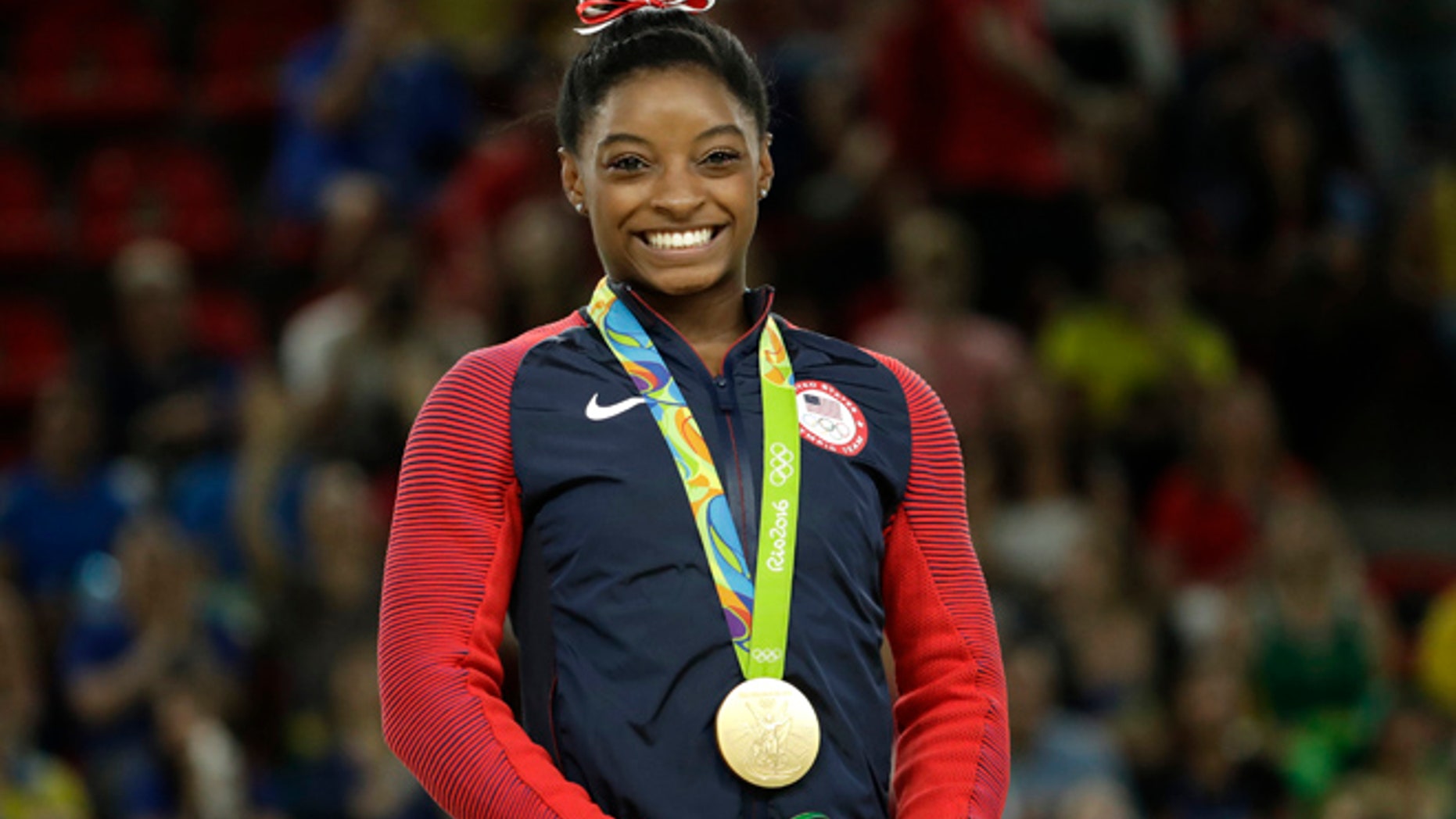 United States' Simone Biles smiles on the podium after winning vault gold during the artistic gymnastics women's apparatus final at the 2016 Summer Olympics in Rio de Janeiro, Brazil, Sunday, Aug. 14, 2016.