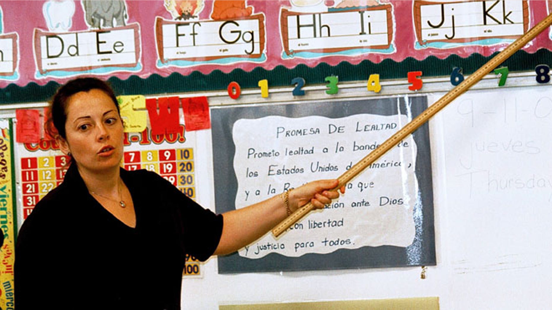 TYLER,TX - SEPTEMBER 11: Lourdes Carmona, a Spanish speaking first grade teacher, instructs a class on the Spanish pronunciations of the alphabet at Birdwell Elementary School September 11, 2003 in Tyler, Texas. Carmona, a native of Spain, was recruited 5 years ago to teach Spanish speaking youngsters reading, writing, and arithmetic in their native language, as there was and continues to be a shortage of bilingual teachers in Texas. Carmona and her husband, also a native of Spain, are both employed by the Tyler Independent School District and permanently live in the east Texas city. (Photo by Mario Villafuerte/Getty Images)