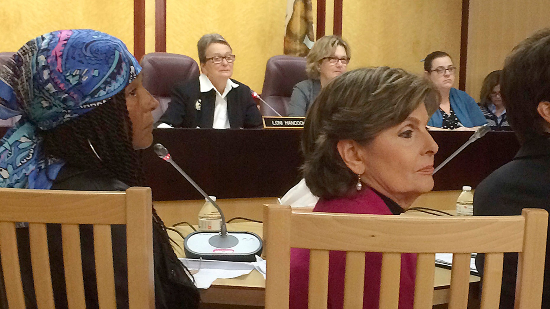 FILE – In this April 12, 2016, file photo, a woman known as "Kacey," front left, one of Bill Cosby's accusers, and attorney Gloria Allred, front right, attend a hearing at the State Capitol in Sacramento, Calif.