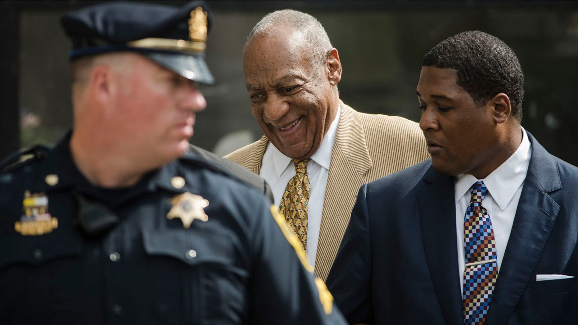 July 7, 2016: Bill Cosby, center, leaves a pretrial hearing in his criminal sex-assault case at Montgomery County Courthouse in Norristown, Pa
