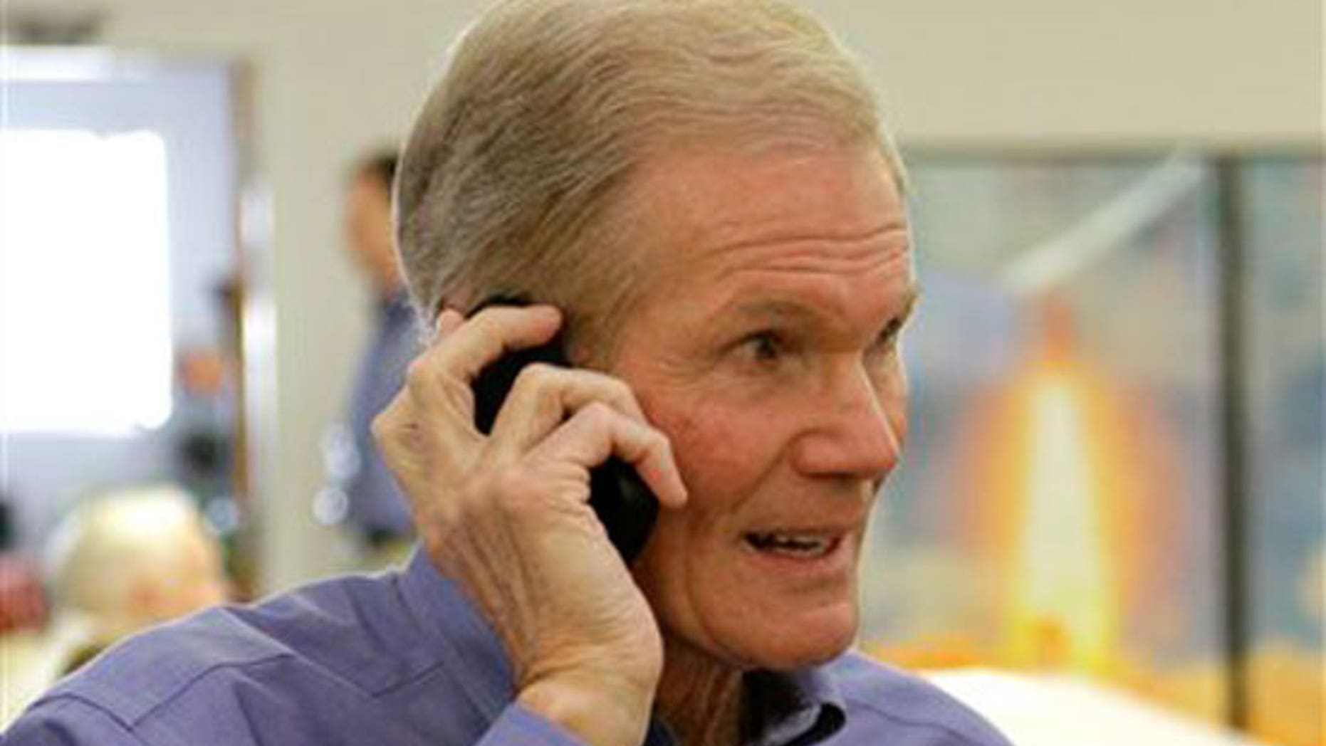 Sen. Bill Nelson, D-Fla., talks on his cell phone at the Kennedy Space Center press building prior to the launch of space shuttle Discovery in Cape Canaveral, Fla., Thursday, Feb. 24, 2011.(AP)