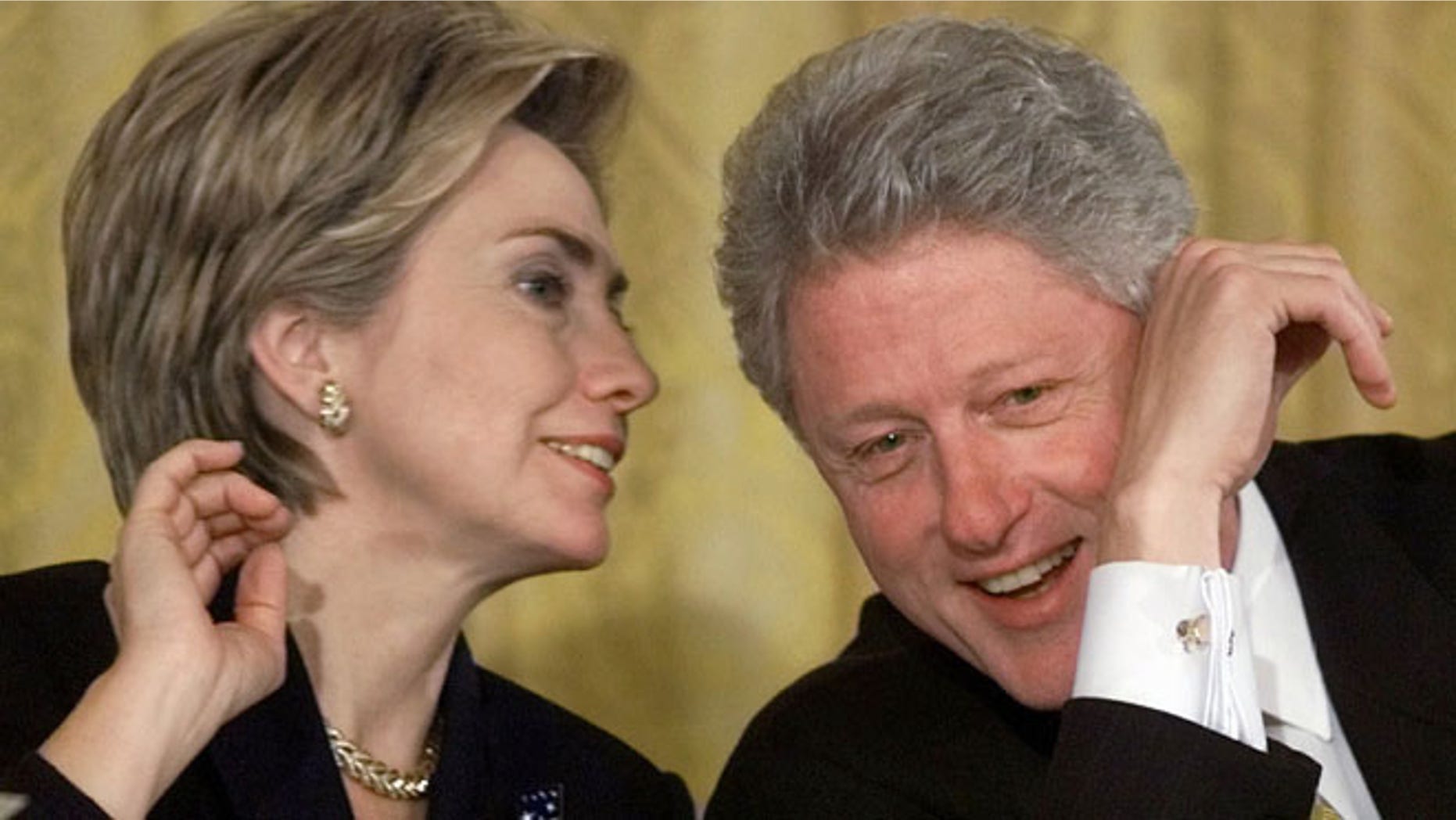 Oct. 22, 1999: President Bill Clinton and first lady Hillary Rodham Clinton talk during the White House Conference on Philanthropy in the East Room of the White House in Washington.